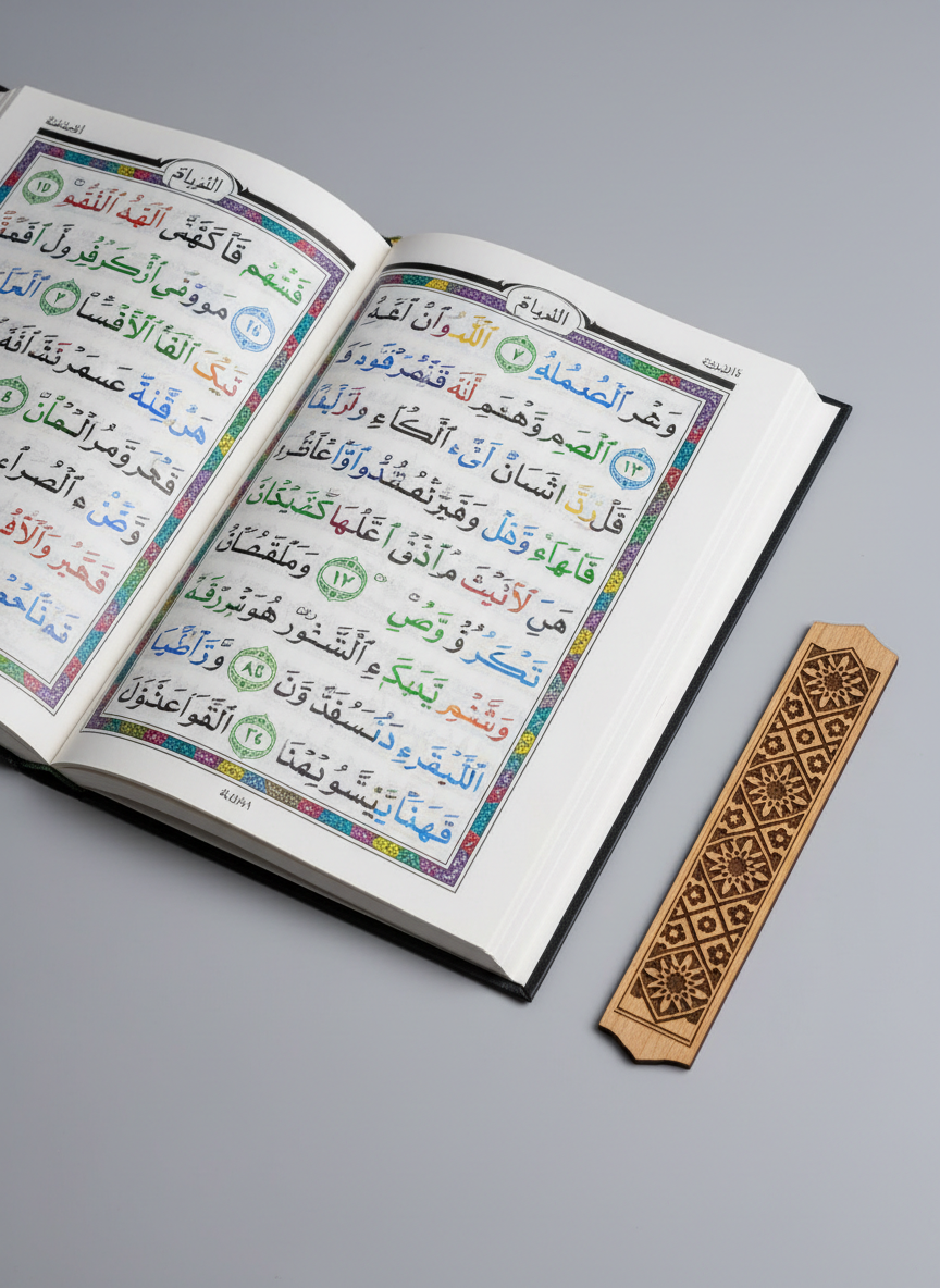 A close-up of a beautifully printed Tajweed color-coded Mushaf laid flat on a smooth, dove-grey table, each rule highlighted in distinct, vivid colors—greens, reds, and blues harmoniously guiding pronunciation. Beside it rests a finely crafted wooden bookmark etched with intricate Islamic geometric patterns. Overhead, soft studio lighting evenly illuminates the page, making each mark and color separation crisp, while casting the faintest halo shadow around the edges of the book. Shot from a slightly elevated angle with sharp focus across the entire page to emphasize structured learning. The photographic style is clean and modern, evoking a sense of respect, precision, and attentive Qur’anic study aligned with professional Tajweed instruction.